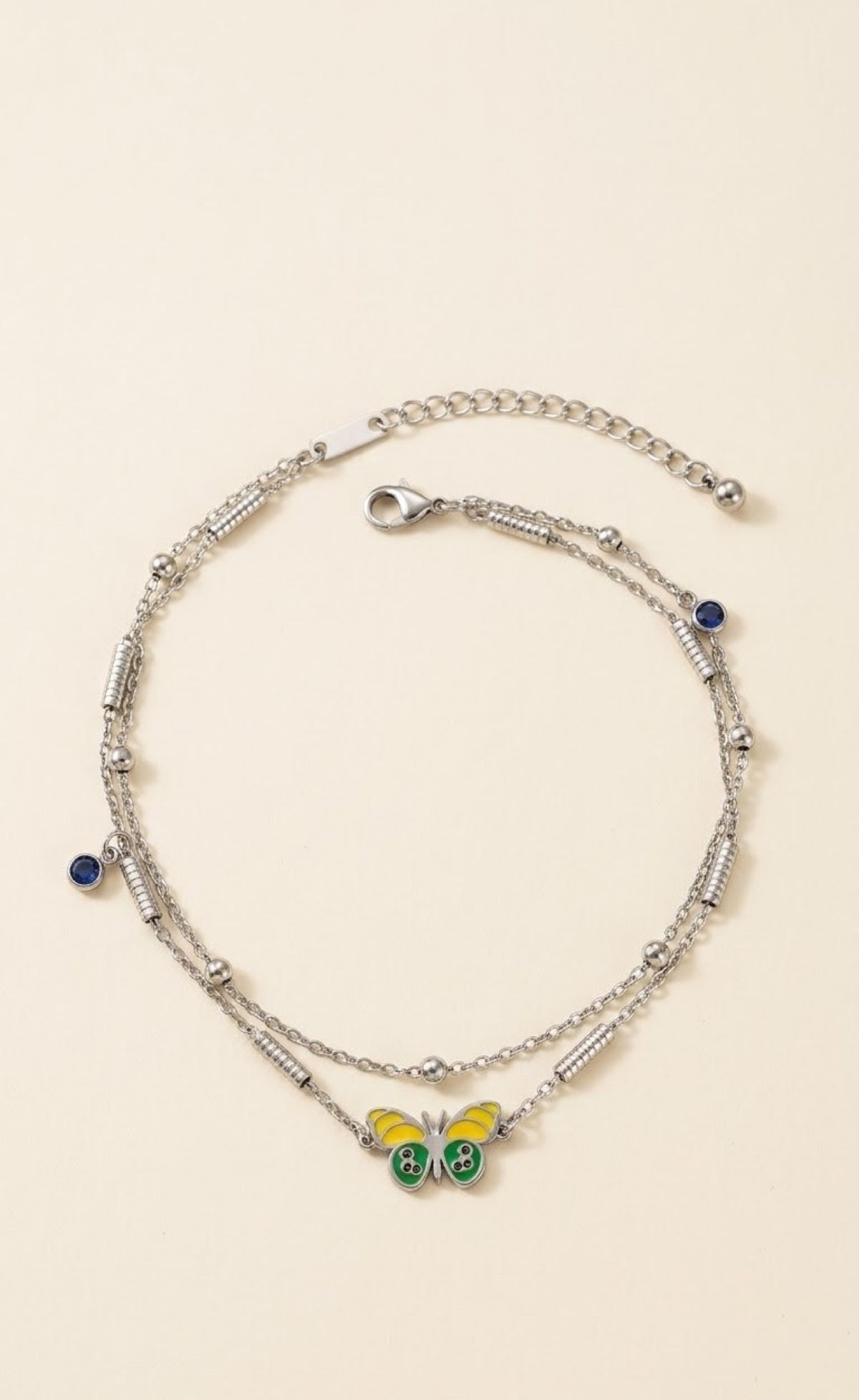 Silver-tone double-strand anklet with yellow-green enamel butterfly and blue crystal drops - view 2