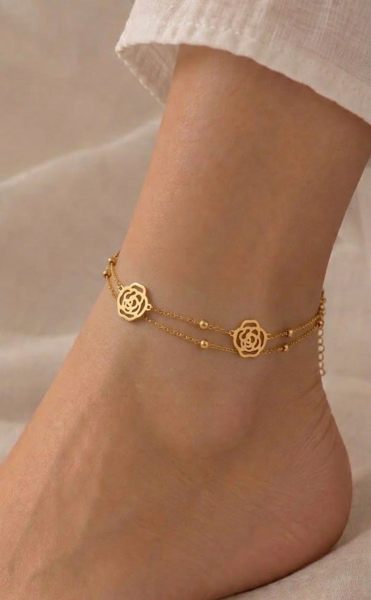 Double-strand gold-tone anklet with openwork rose medallions