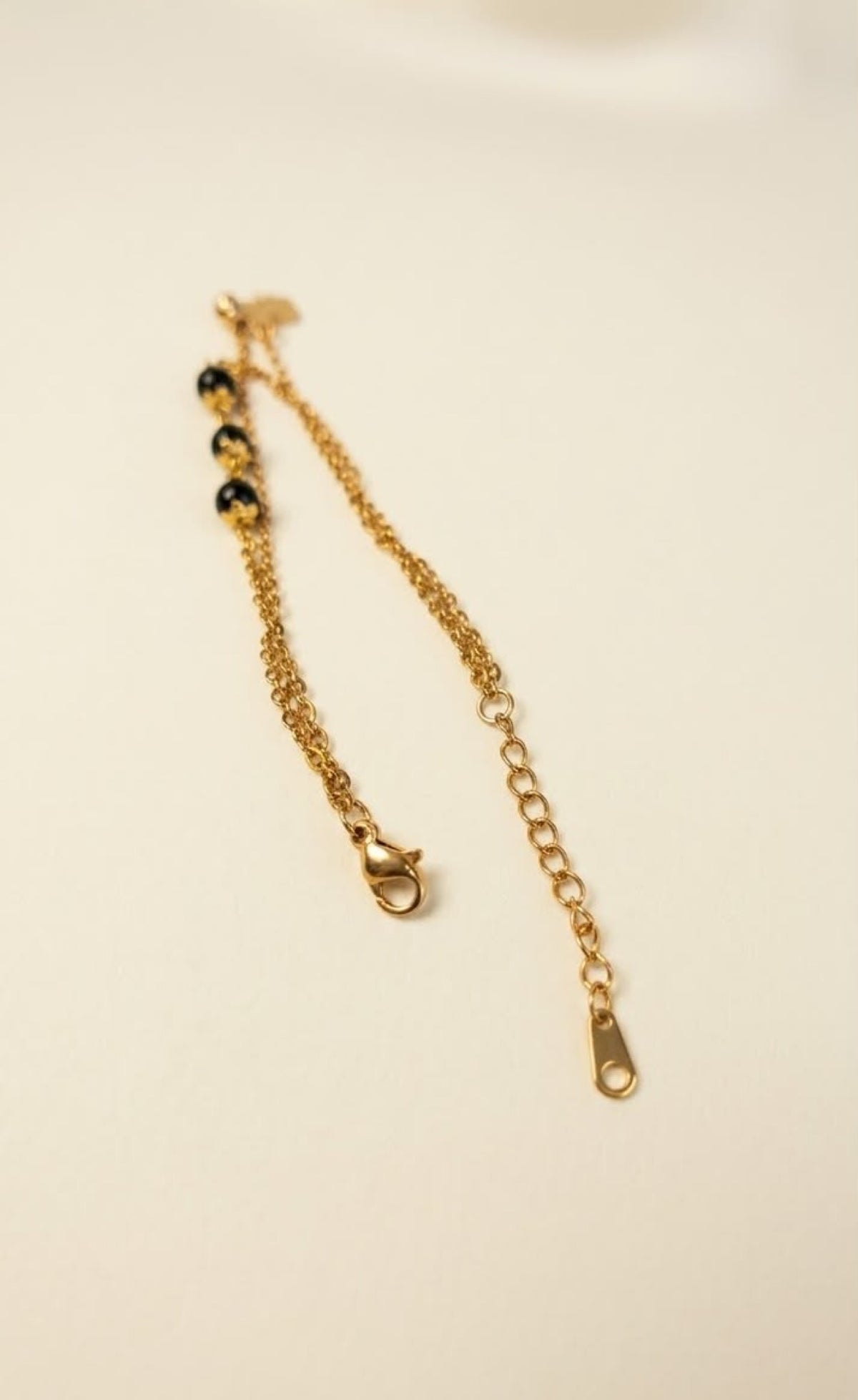 Gold-tone double-layer anklet with dark green beads and four-leaf clover charm - view 3