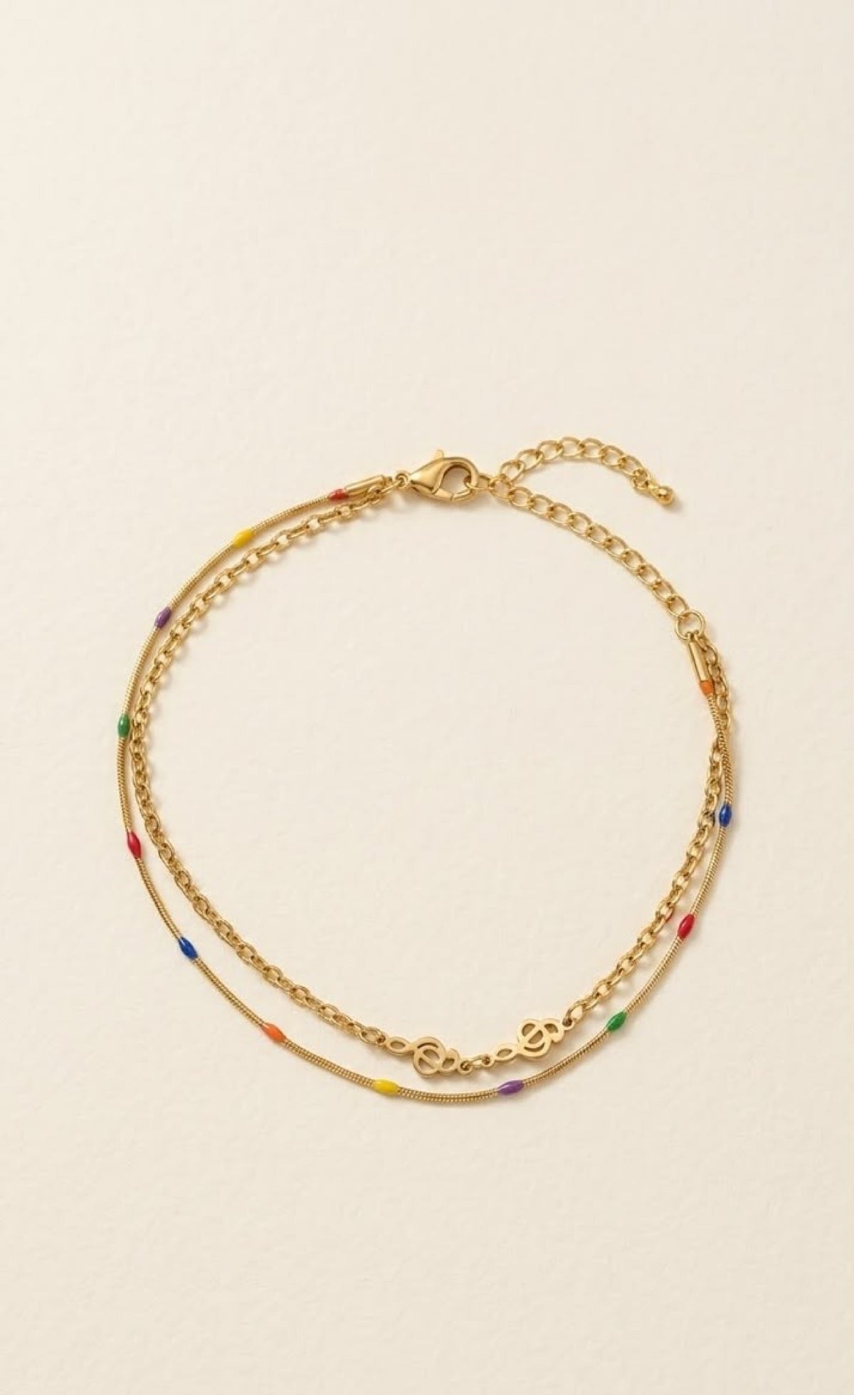 Pair of gold-tone layered anklets with rainbow enamel dots and swirl links - view 2