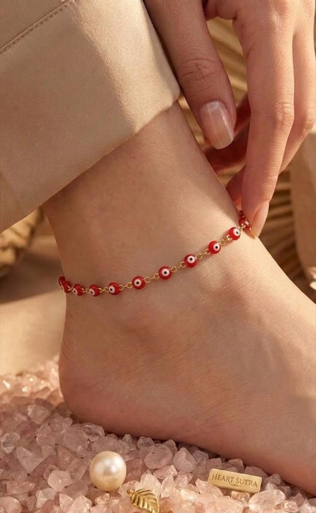 Gold-tone anklet with red enamel evil eye beads