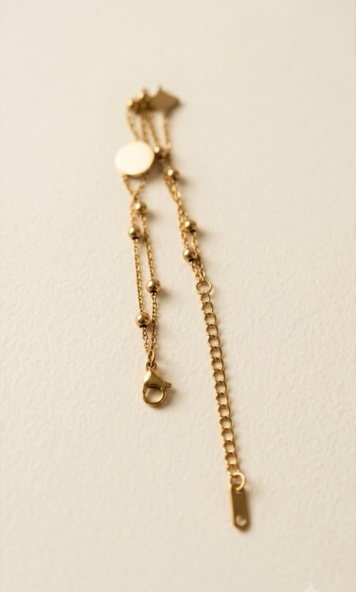 Double-strand gold-tone anklet with black enamel clover and star charms - view 3