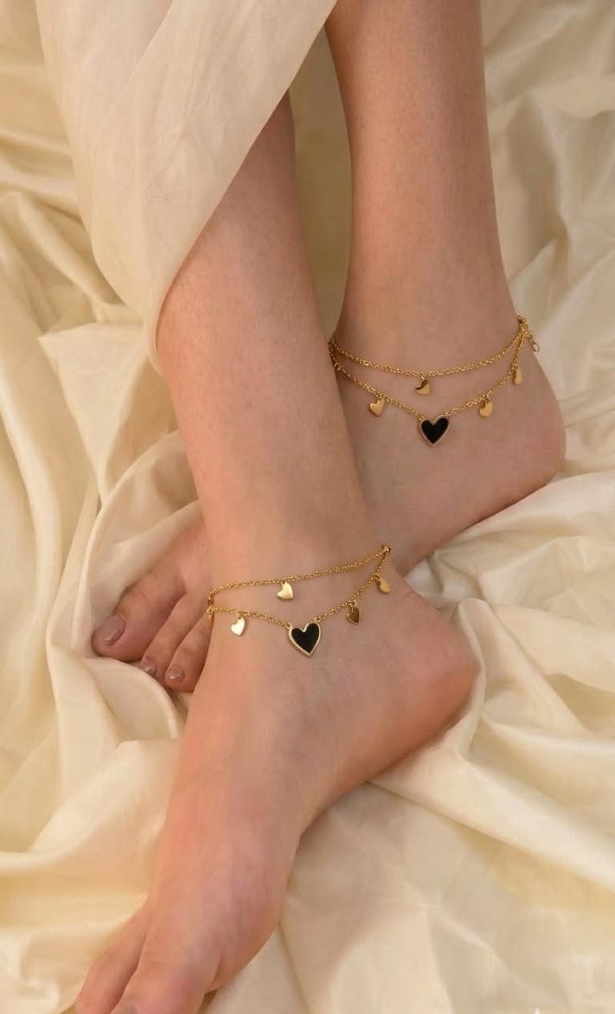 Pair of gold-tone double-layer anklets with mini hearts and black enamel heart