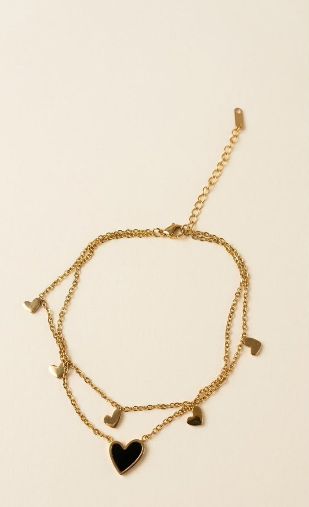 Pair of gold-tone double-layer anklets with mini hearts and black enamel heart - view 2