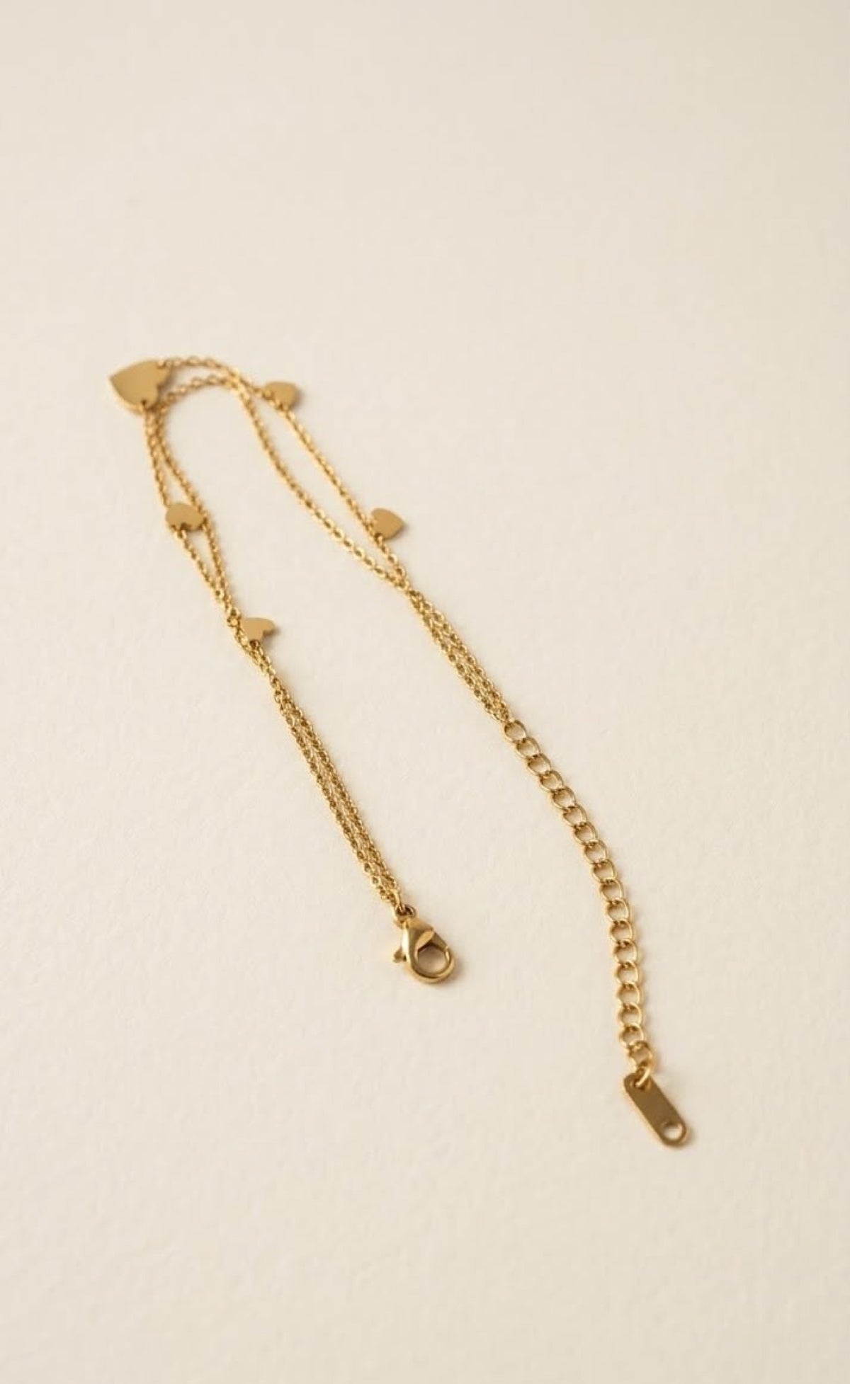 Pair of gold-tone double-layer anklets with mini hearts and black enamel heart - view 3
