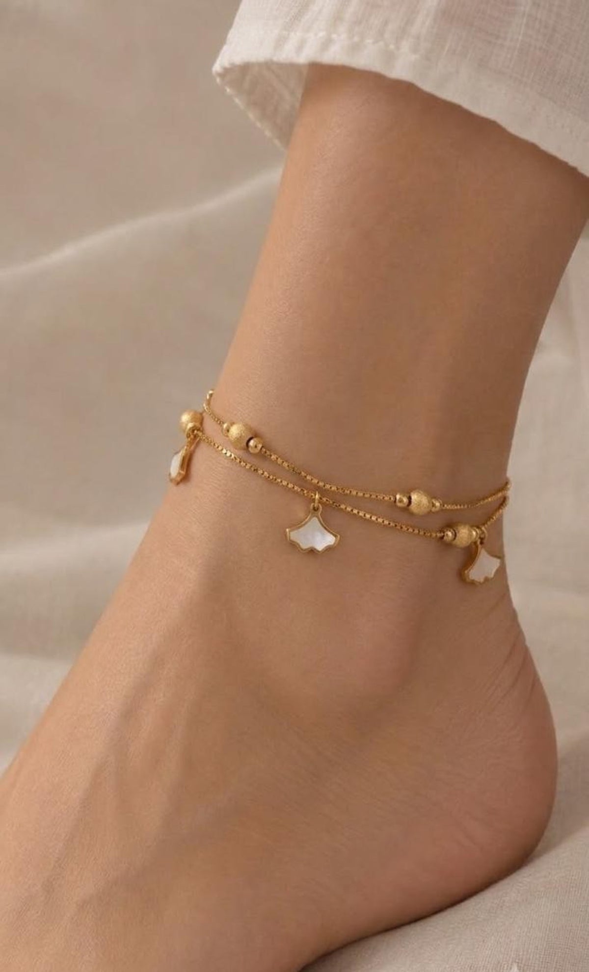 Double box-chain gold-tone anklet with frosted beads and white ginkgo leaf charms
