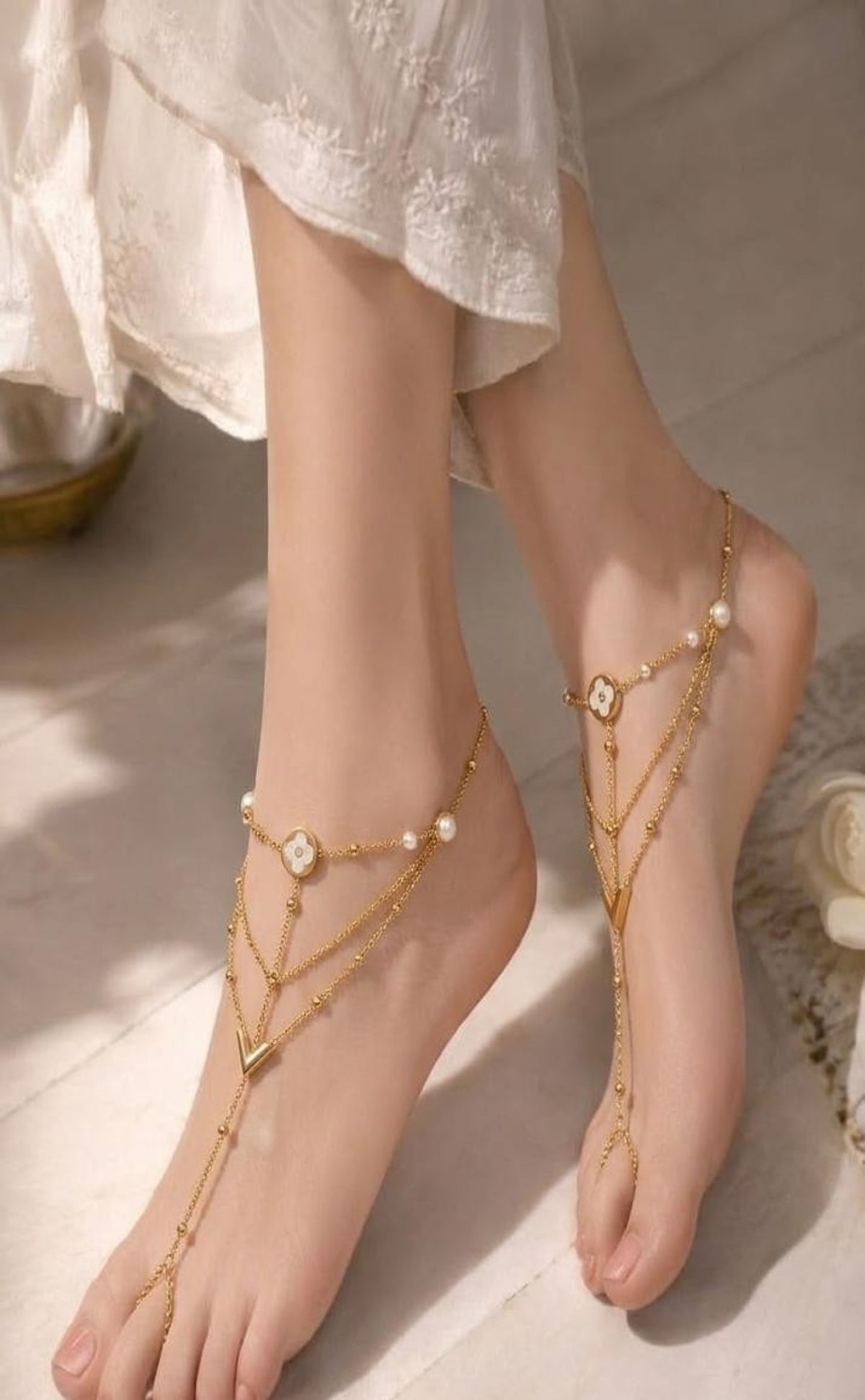 Pair of gold-tone barefoot anklets with white clover medallion, faux pearls and toe loop