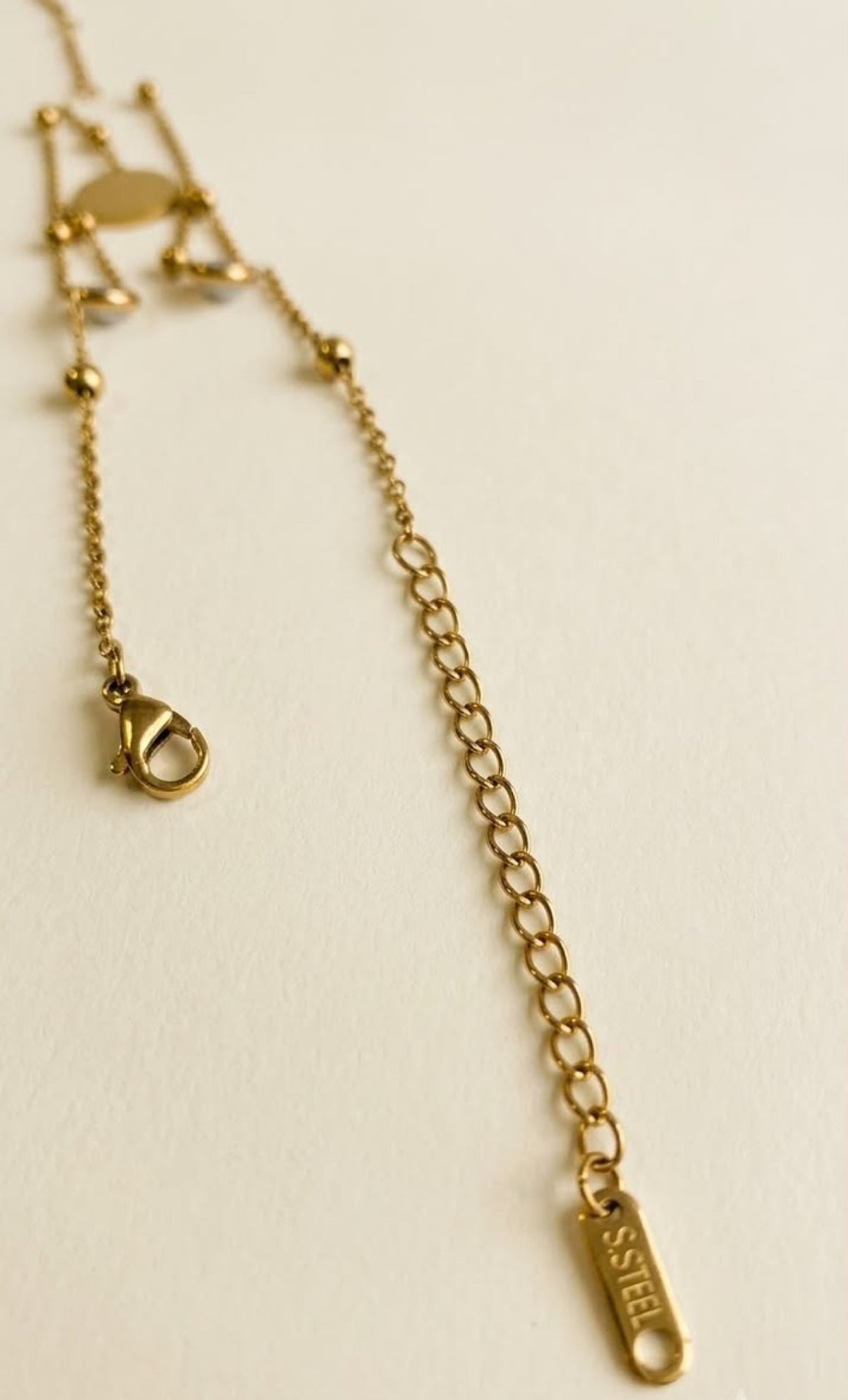 Pair of gold-tone barefoot anklets with white clover medallion, faux pearls and toe loop - view 3
