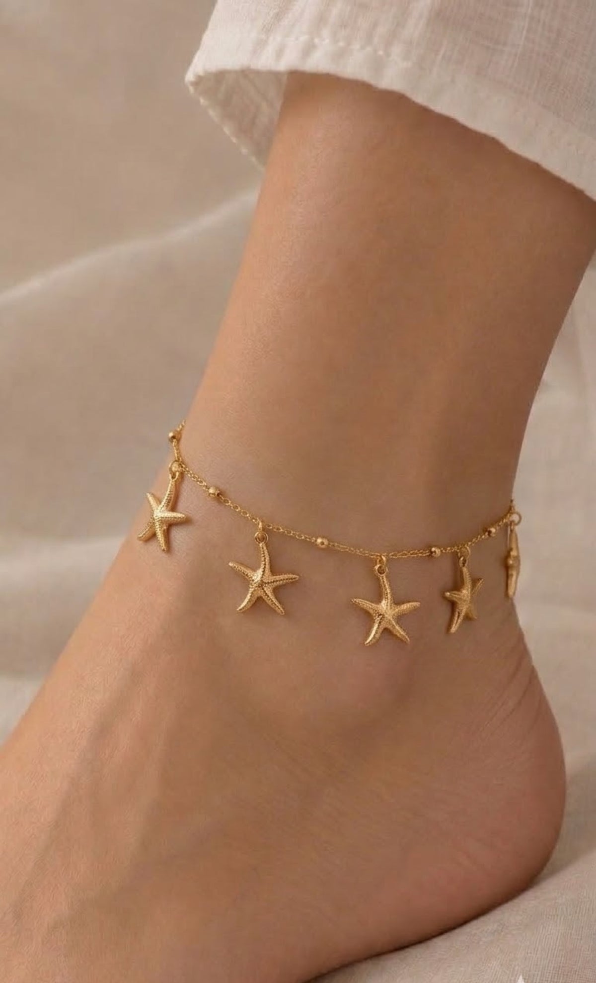 Gold-tone anklet with dangling textured starfish charms
