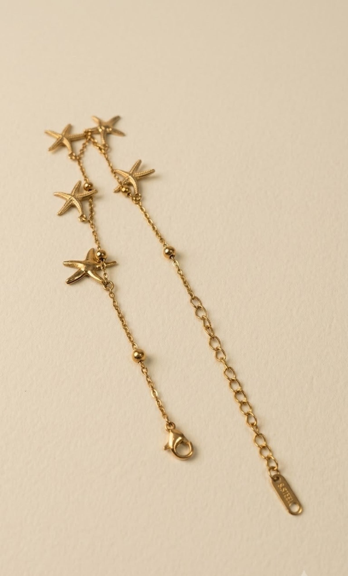 Gold-tone anklet with dangling textured starfish charms - view 2