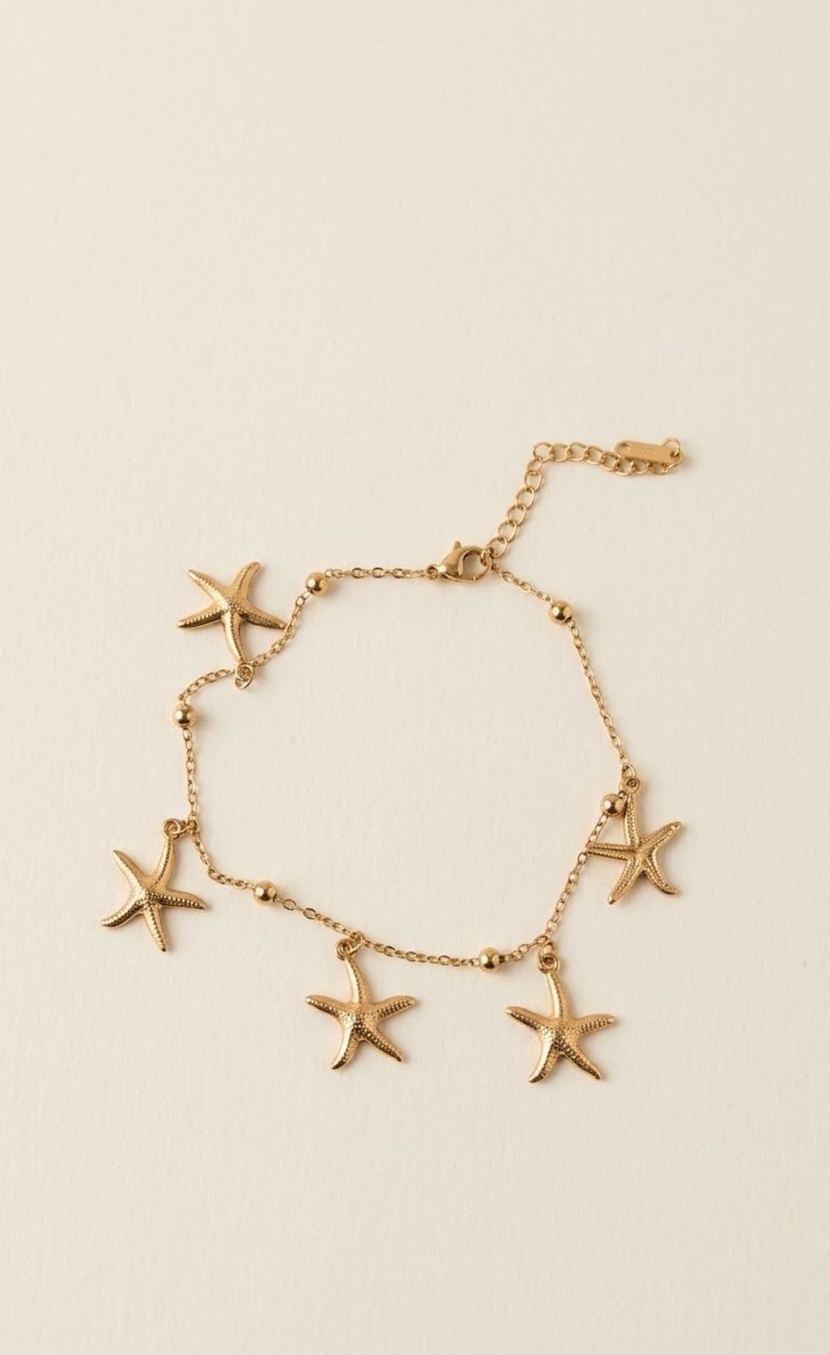 Gold-tone anklet with dangling textured starfish charms - view 3