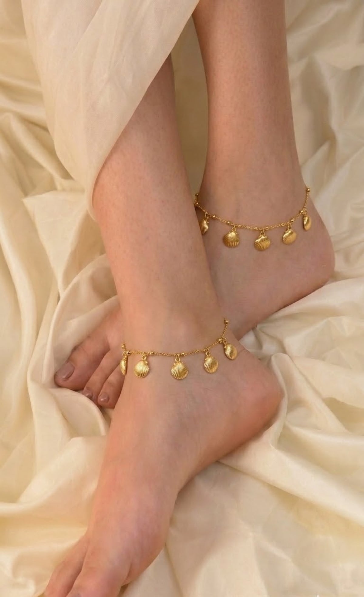 Pair of gold-tone anklets with ridged clamshell charms