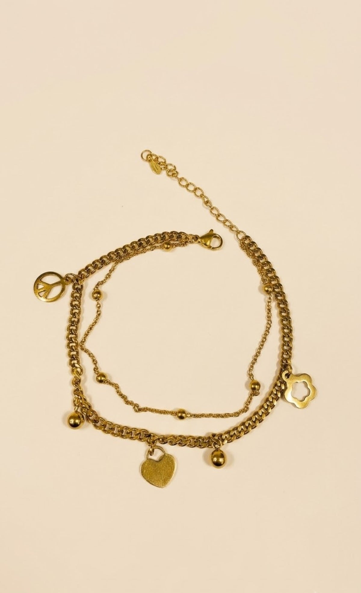Pair of layered gold-tone anklets with heart, flower and peace charms - view 2