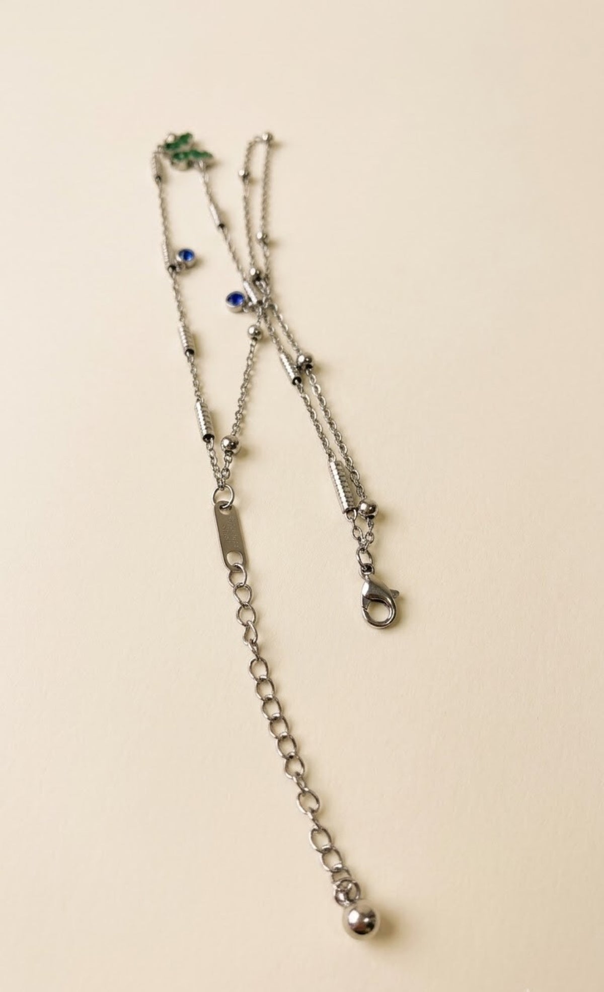 Pair of silver-tone layered anklets with green enamel butterfly and blue stones - view 3