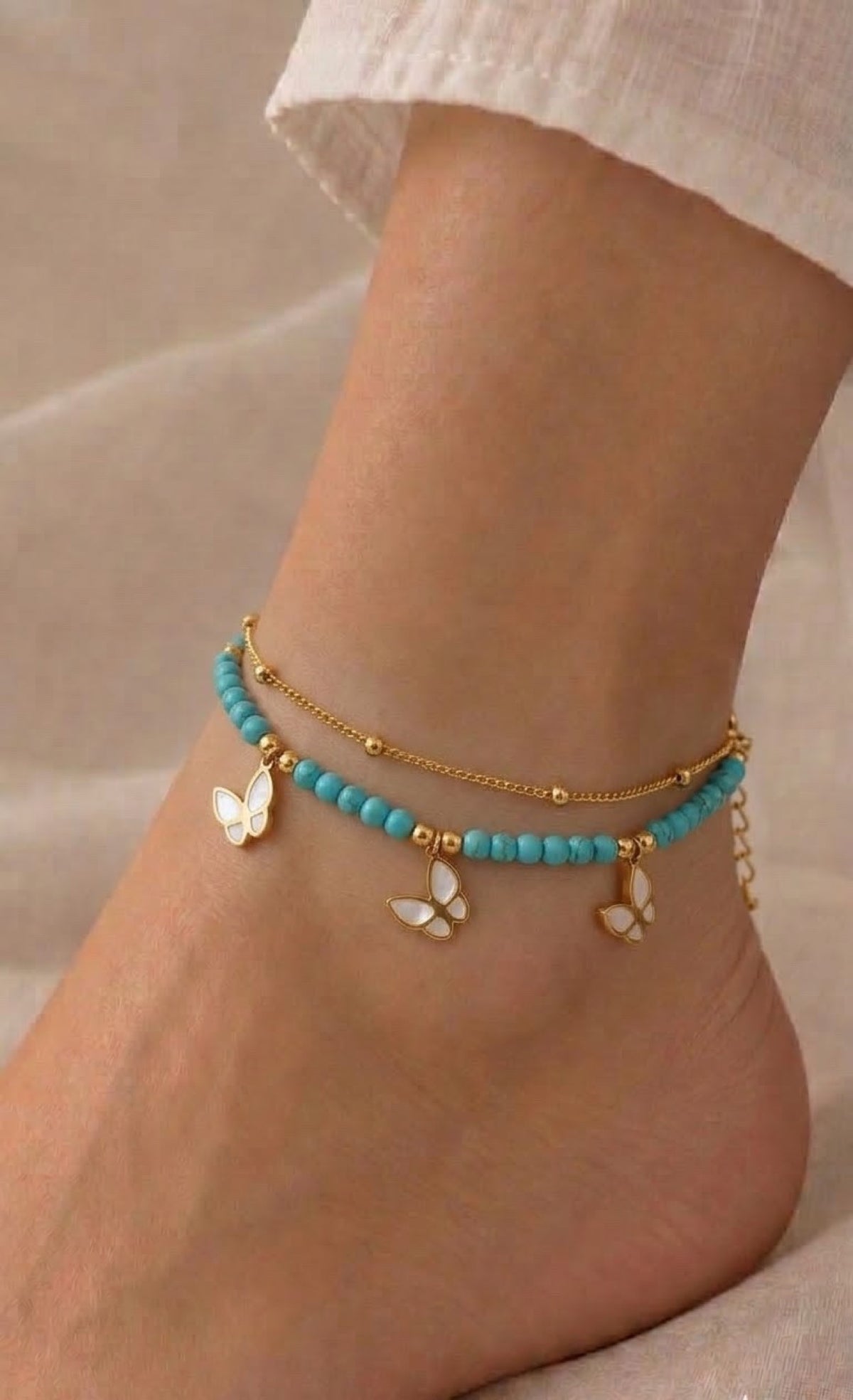 Gold-tone layered anklet with turquoise beads and white butterfly charms