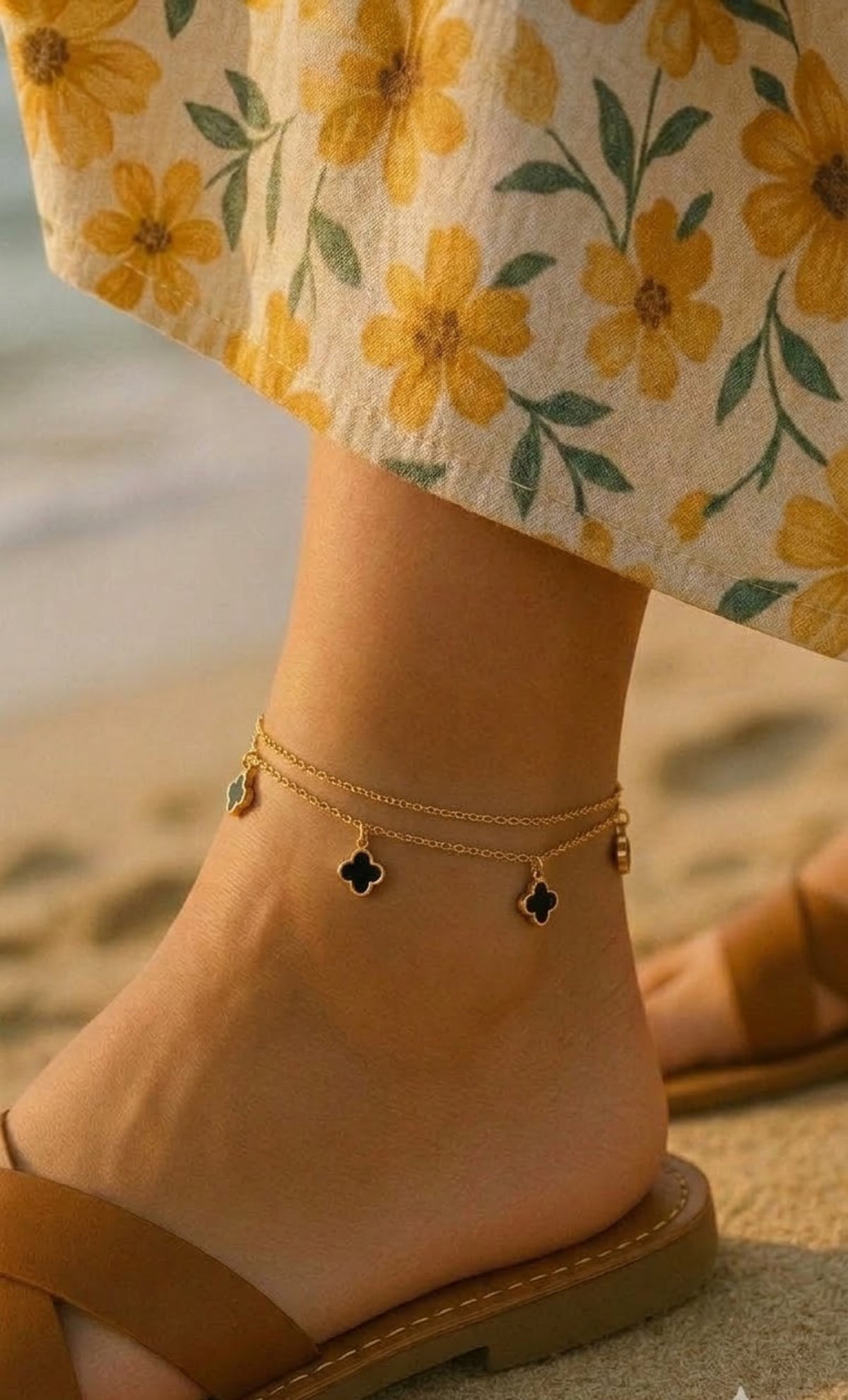 Gold-tone double-chain anklet with black four-leaf clover charms