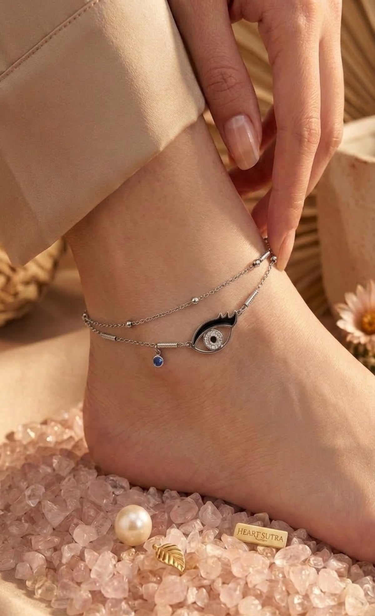 Silver-tone layered anklet with black enamel crystal eye charm and blue stone