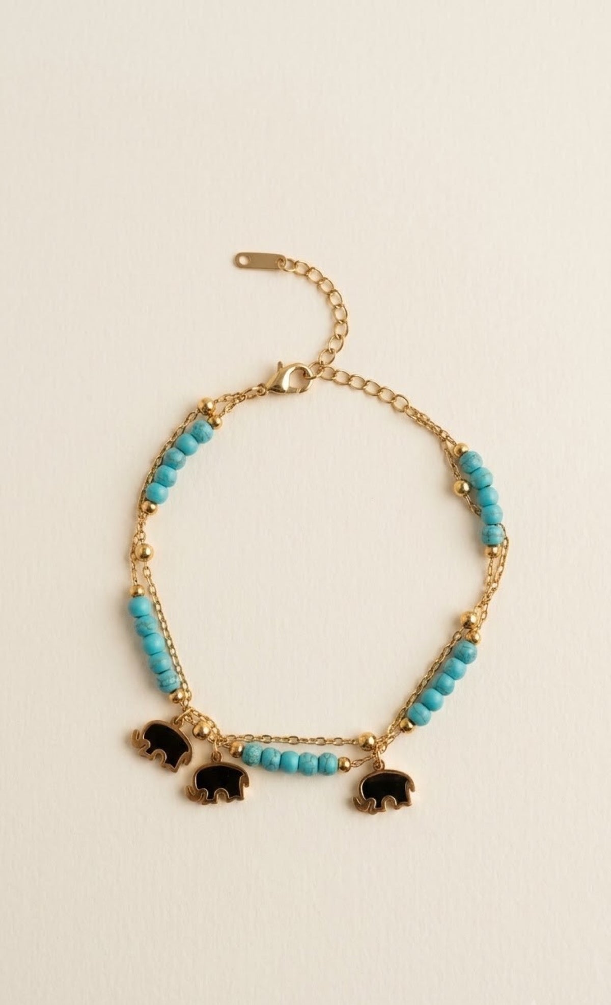 Pair of gold-tone anklets with turquoise beads and black elephant charms - view 2