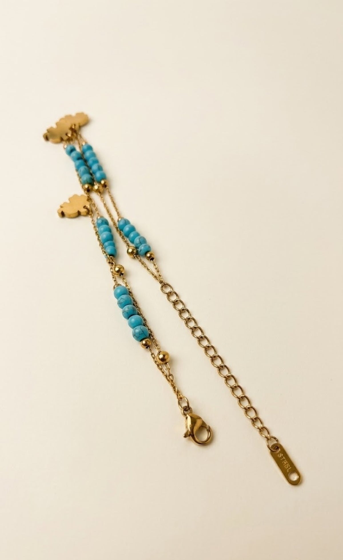 Pair of gold-tone anklets with turquoise beads and black elephant charms - view 3