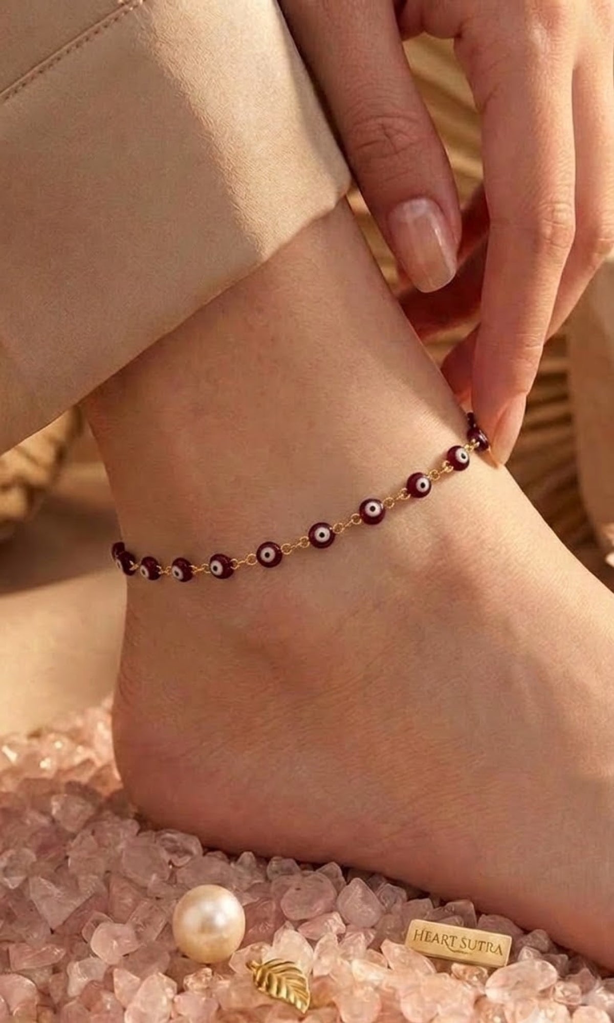Gold-tone anklet with maroon enamel evil eye beads