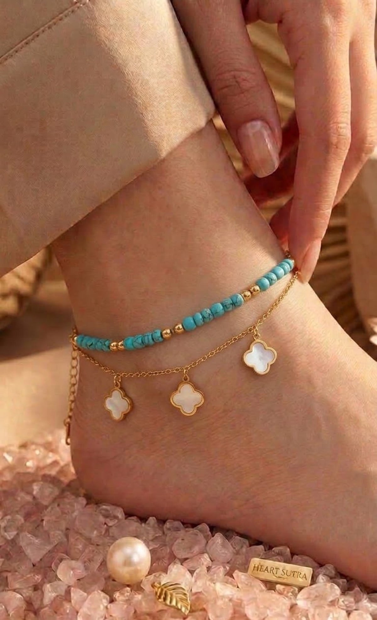 Gold-tone layered anklet with turquoise beads and white quatrefoil charms