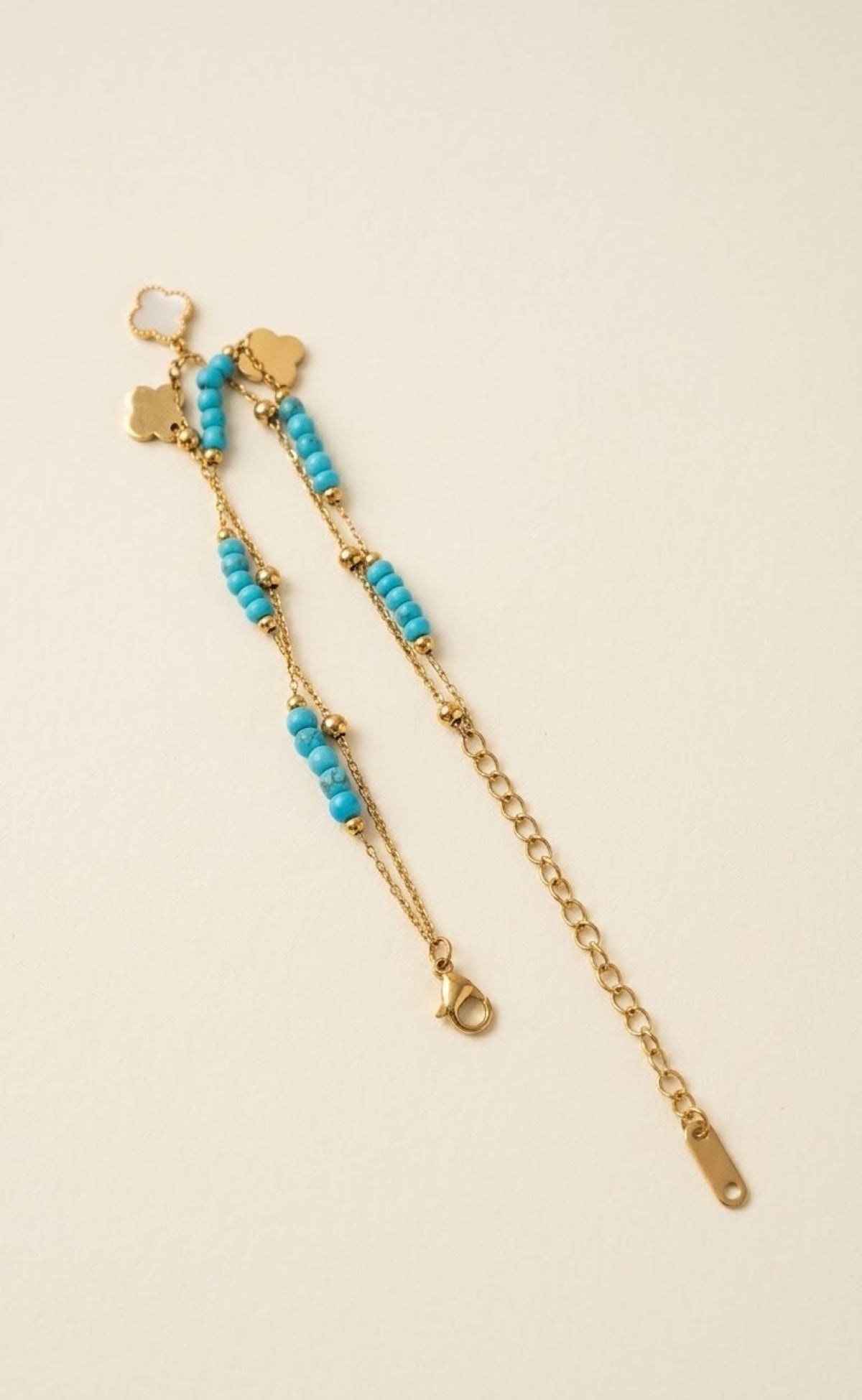 Gold-tone layered anklet with turquoise beads and white quatrefoil charms - view 3