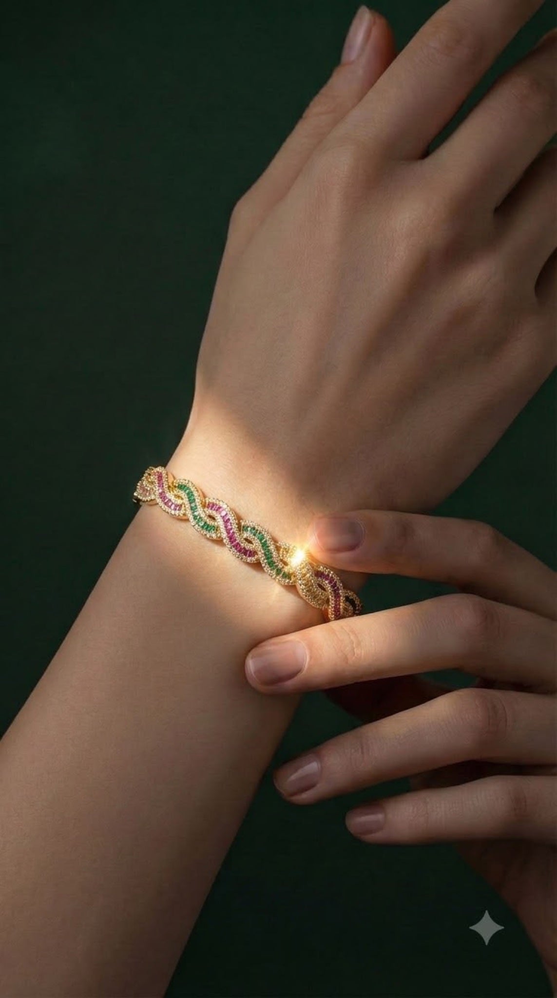 Gold-tone twisted rope bracelet with pink and green crystals