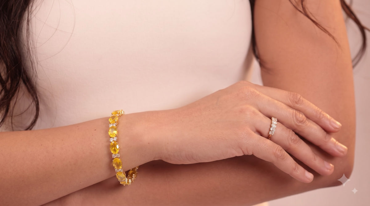 Gold-tone tennis bracelet with yellow oval stones