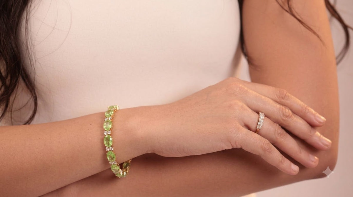 Gold-tone tennis bracelet with lime-green oval stones