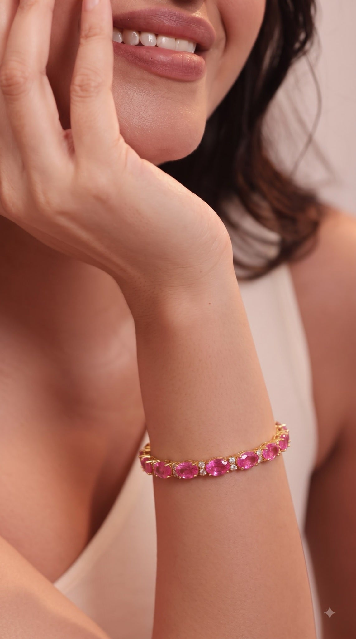 Gold-tone tennis bracelet with pink oval stones