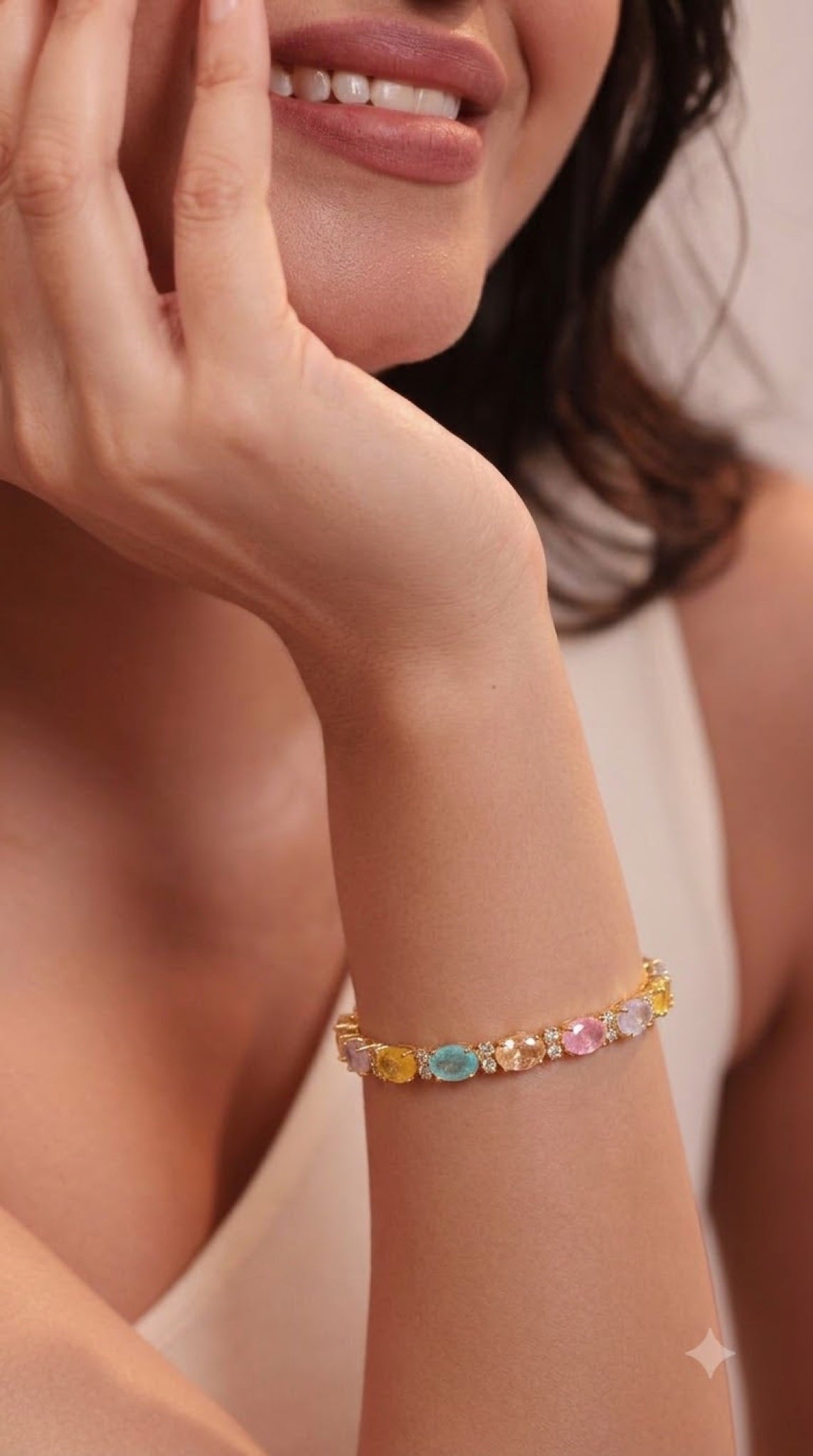 Gold-tone tennis bracelet with pastel multicoloured oval stones