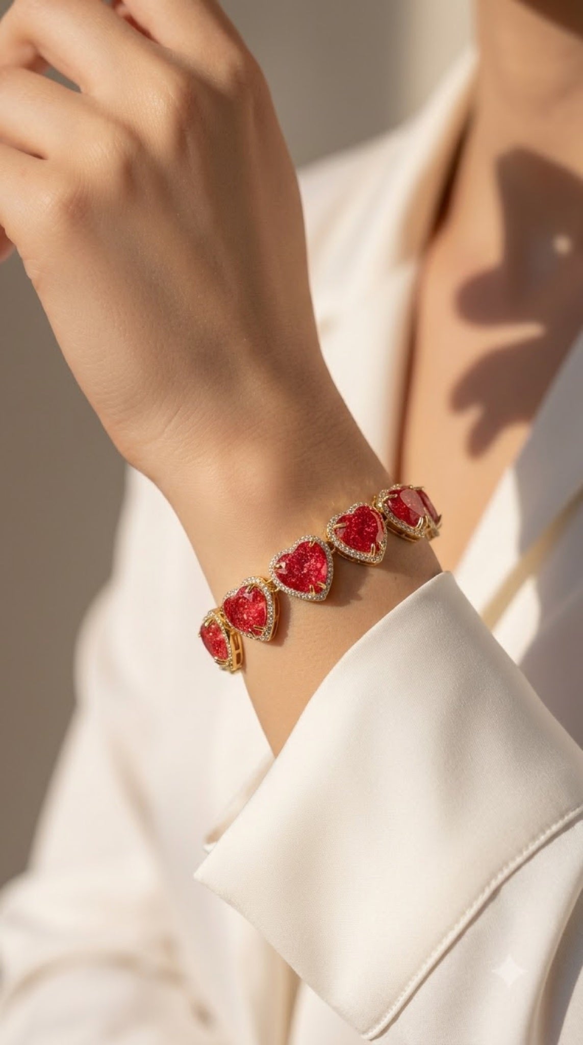 Gold-tone bracelet of red heart stones with crystal halos