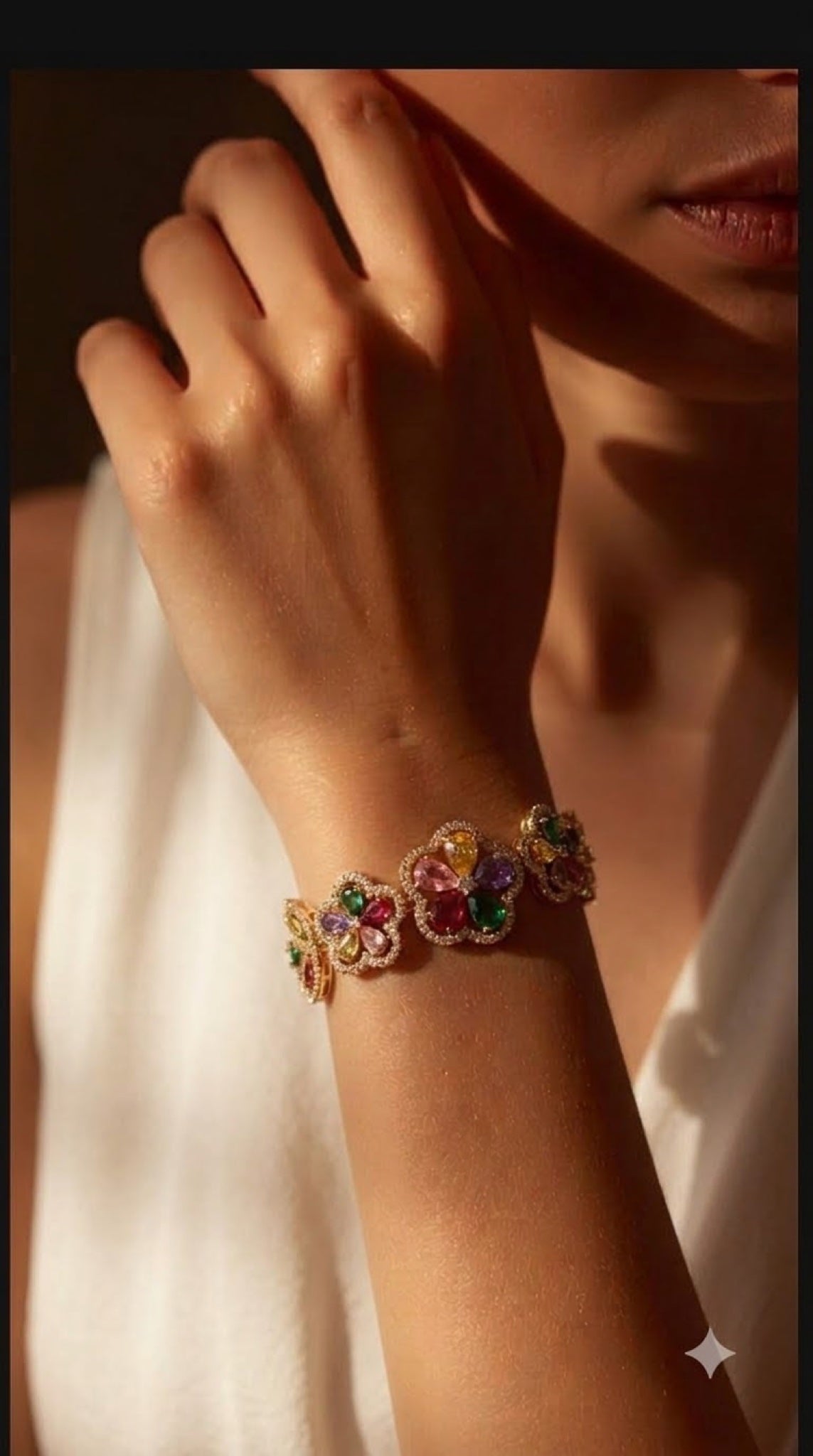 Gold-tone floral bracelet with multicoloured crystal blossoms