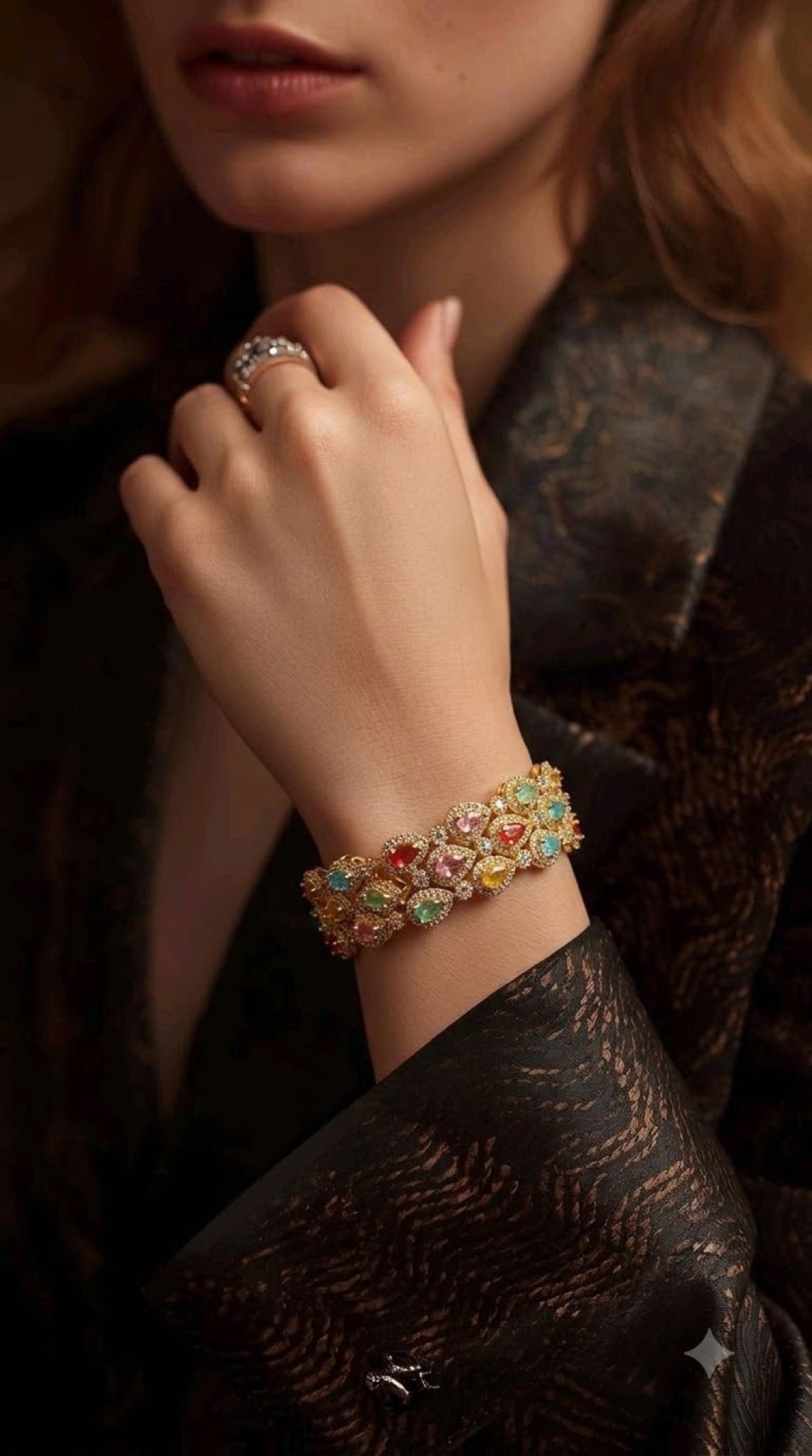 Wide gold-tone bracelet with multicoloured oval and pear stones