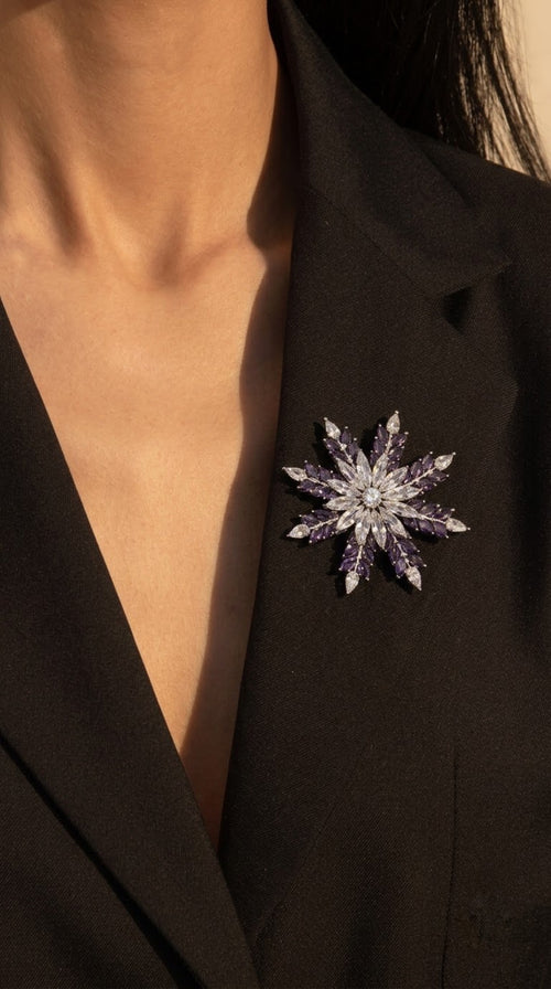 Silver-tone starburst brooch with clear and purple marquise crystals