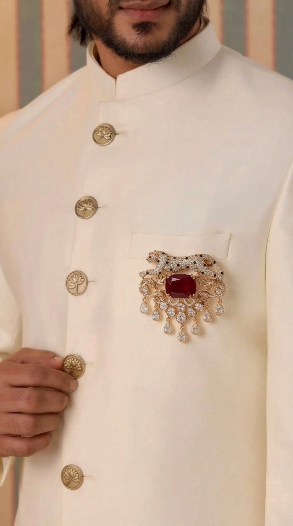 Gold-tone leopard brooch with ruby-red stone and polki-look drops