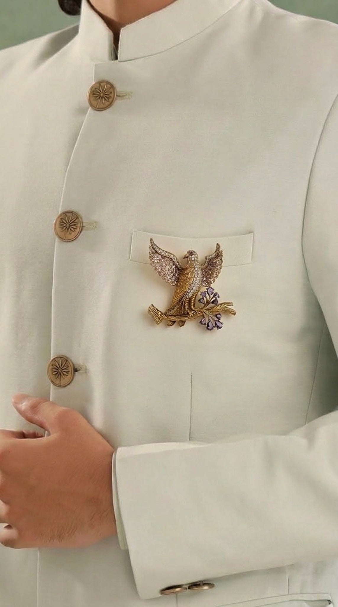 Gold-tone eagle brooch with crystal wings on a branch with lilac stones