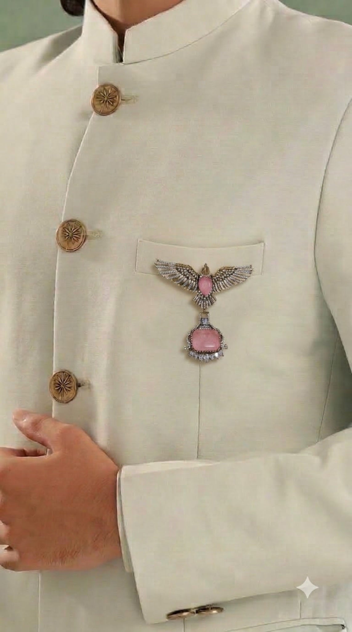 Antique gold-tone winged brooch with pink stone drop