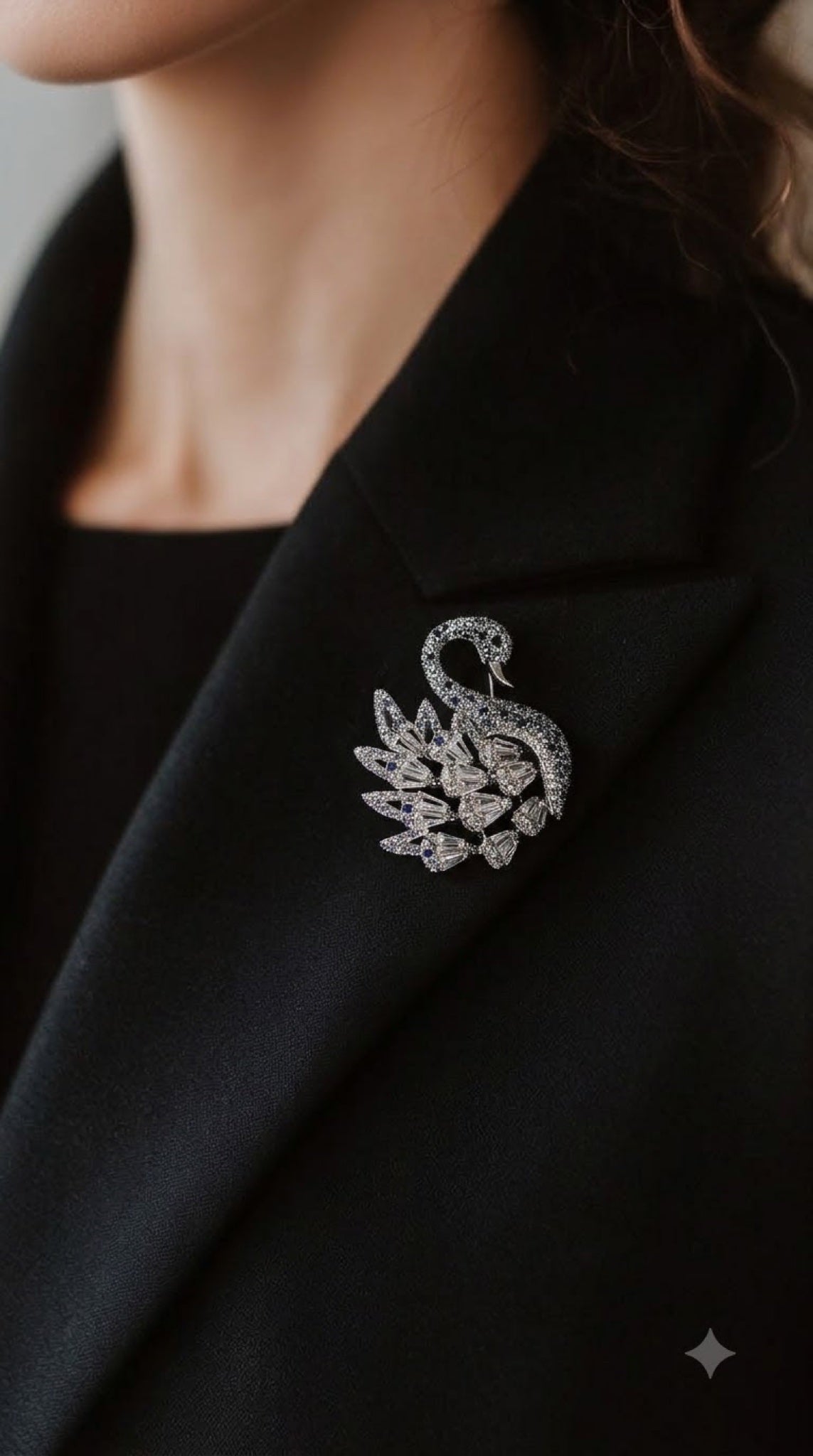 Silver-tone swan brooch with blue stones and clear crystal wings