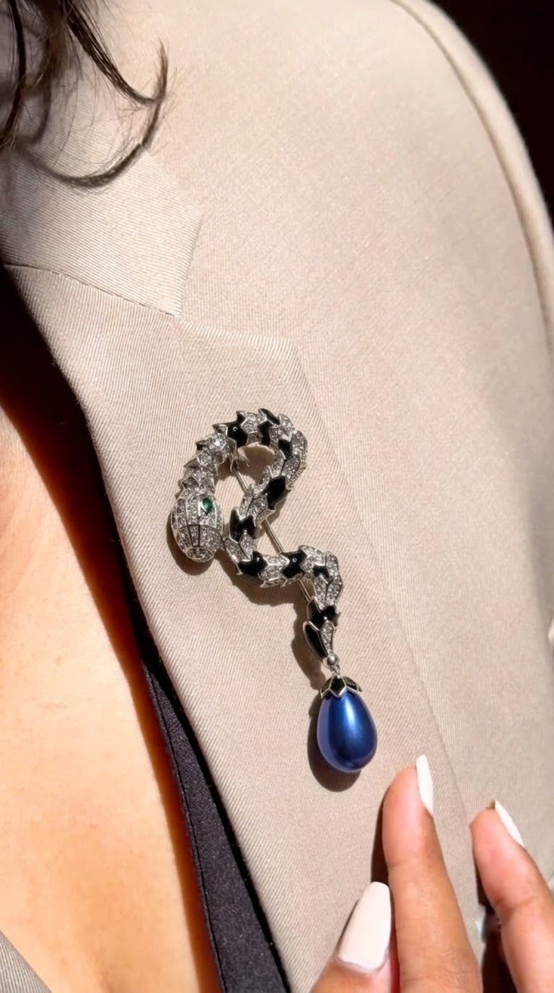 Silver-tone snake brooch with black enamel and blue faux pearl drop