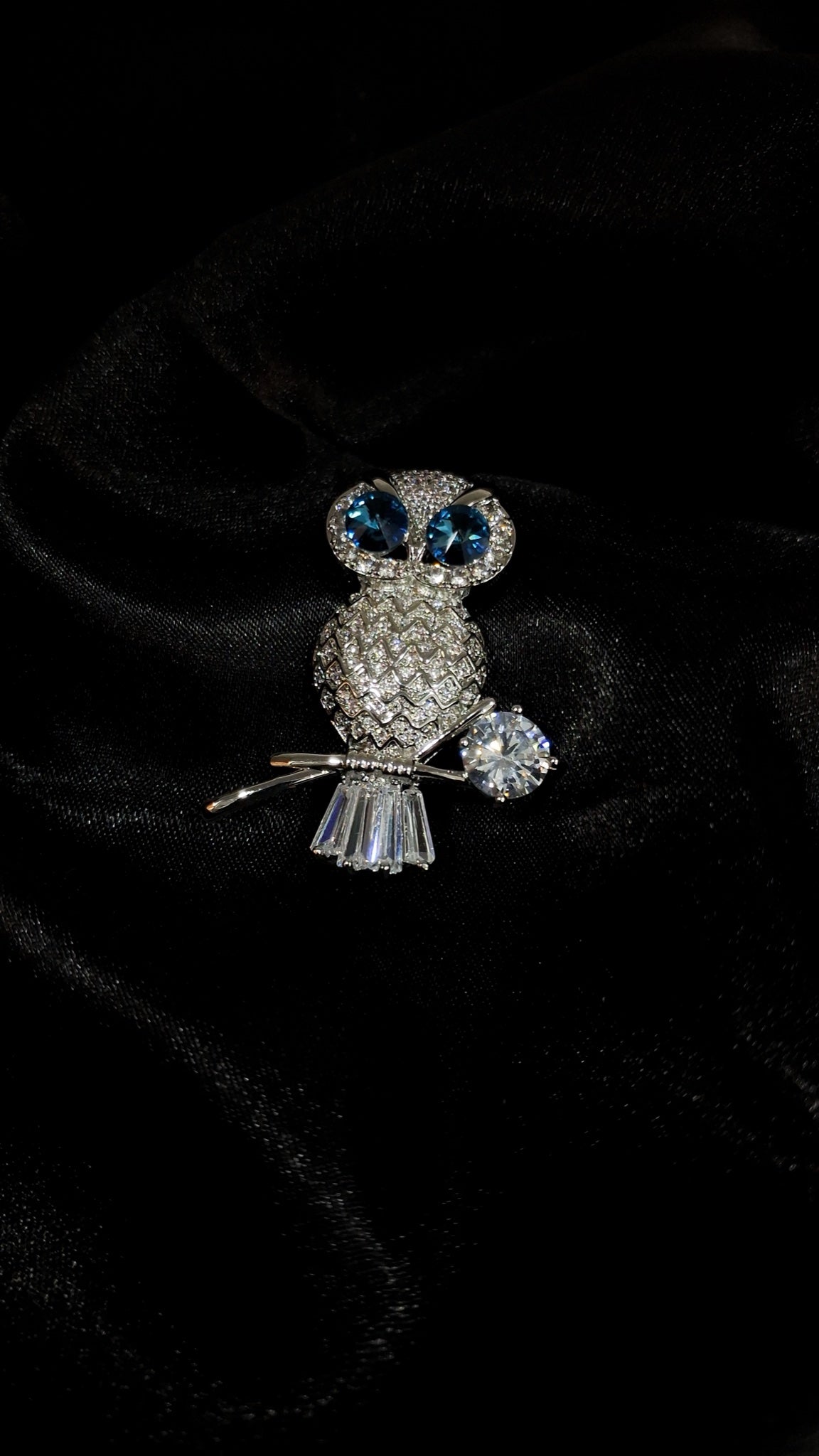 Silver-tone owl brooch with blue crystal eyes perched on a branch - view 2