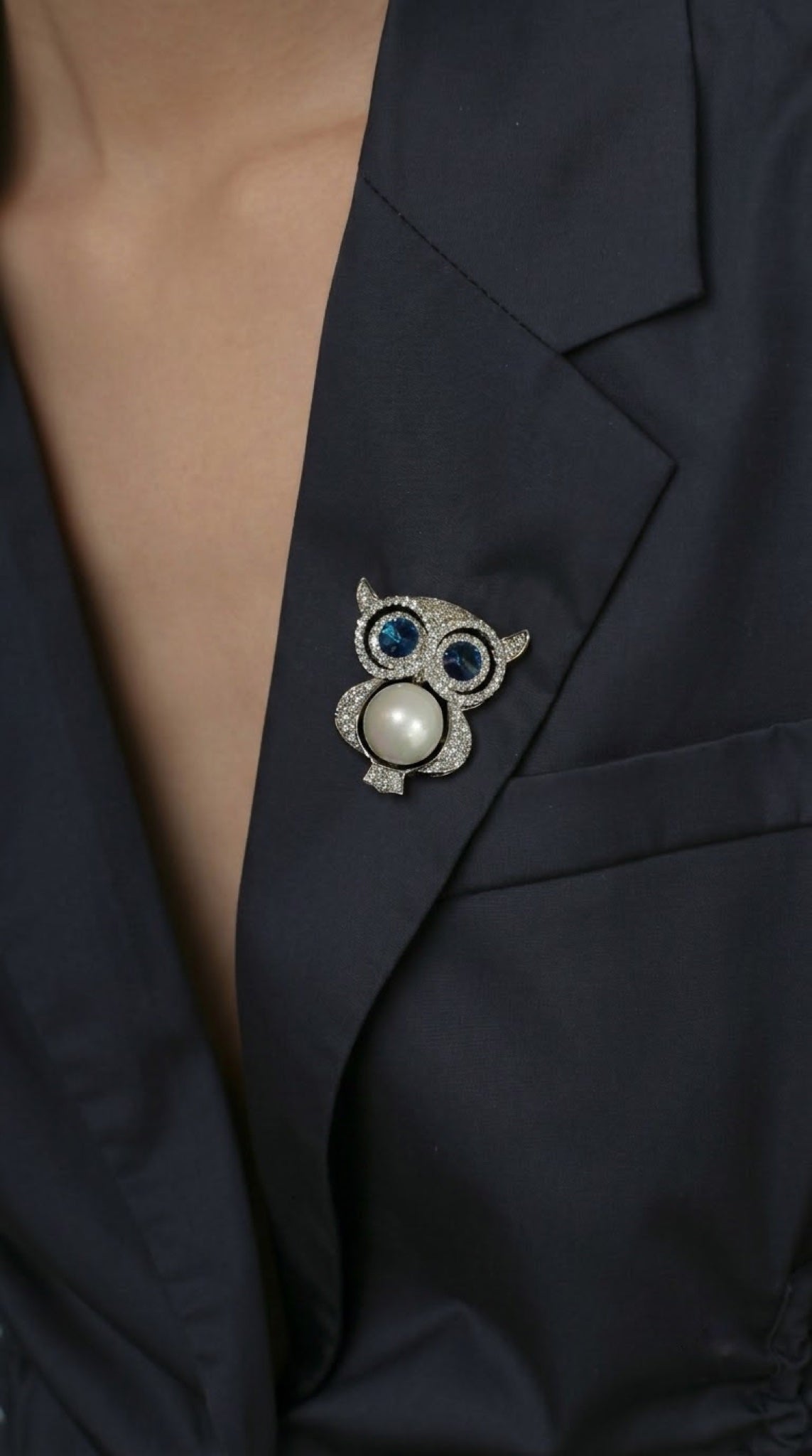 Silver-tone owl brooch with faux pearl belly and blue crystal eyes