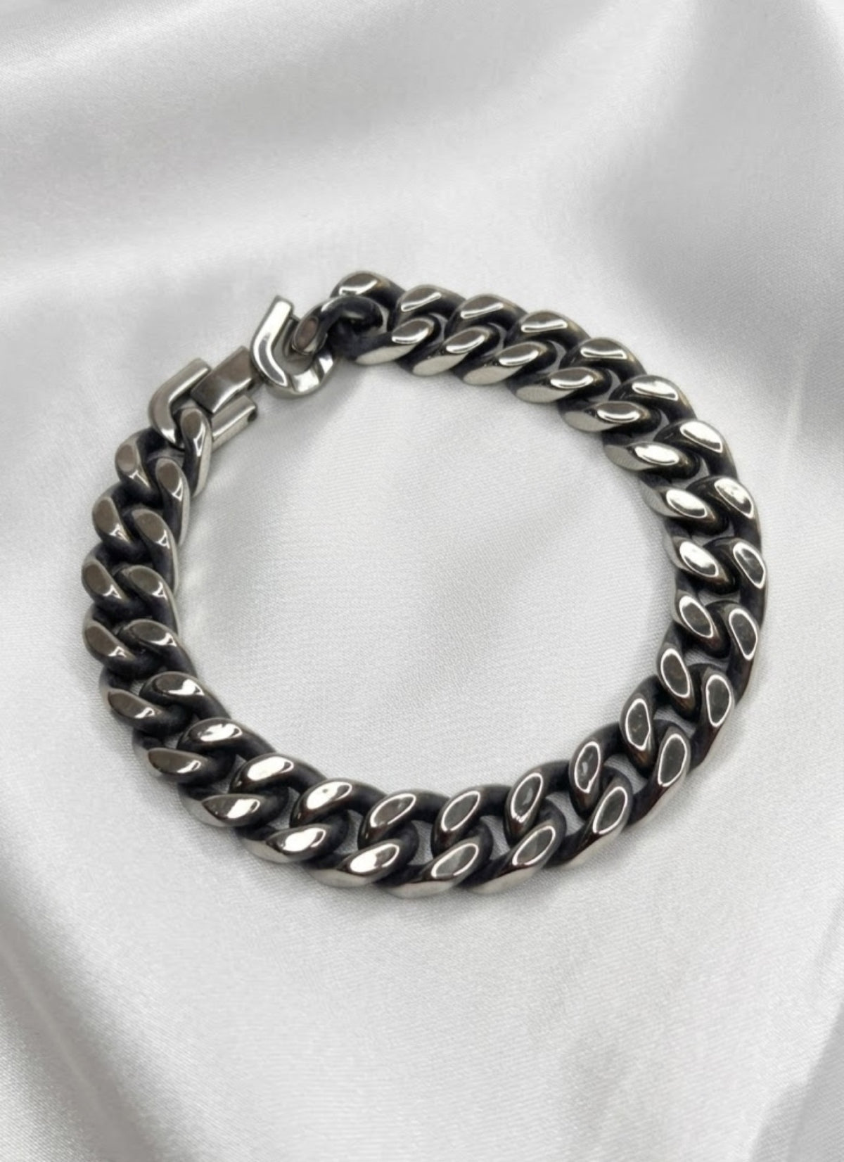 Classic curb fold-over bracelet in gold-tone and antiqued silver-tone on white satin - view 3