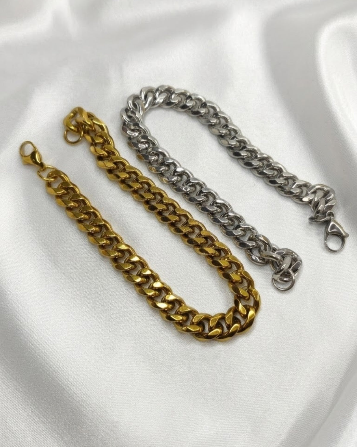 Everyday curb link bracelet in gold-tone and silver-tone on white satin
