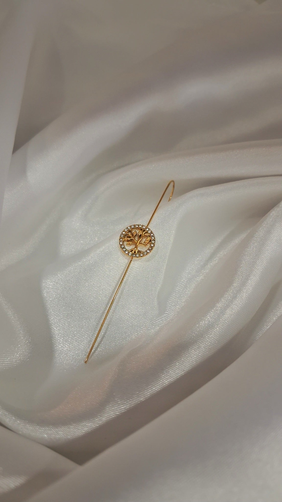 Gold-tone ear pin cuff with crystal-ringed tree of life charm