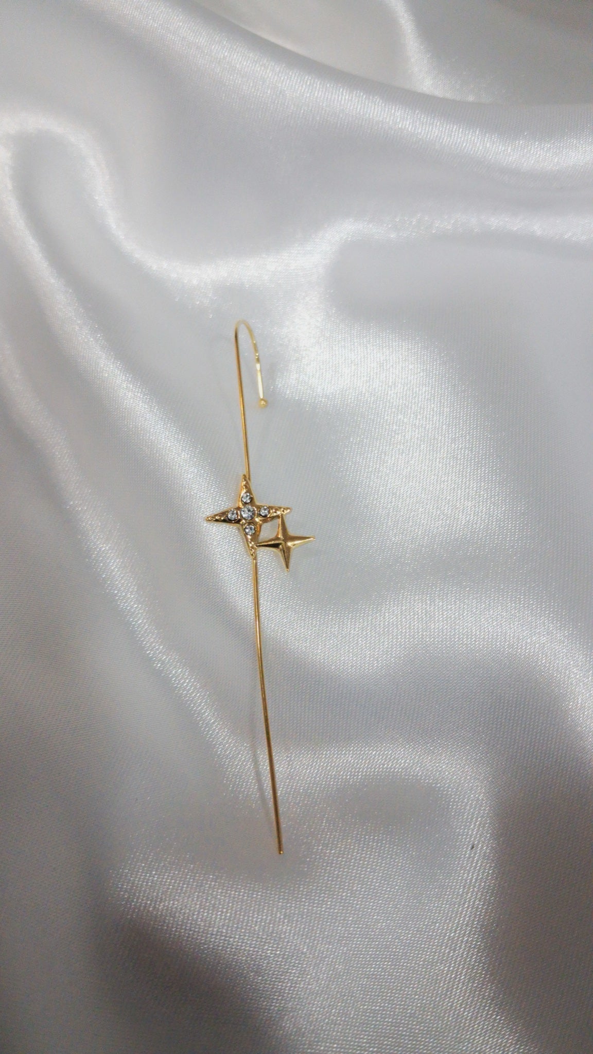 Gold-tone ear pin cuff with two four-point stars and crystals