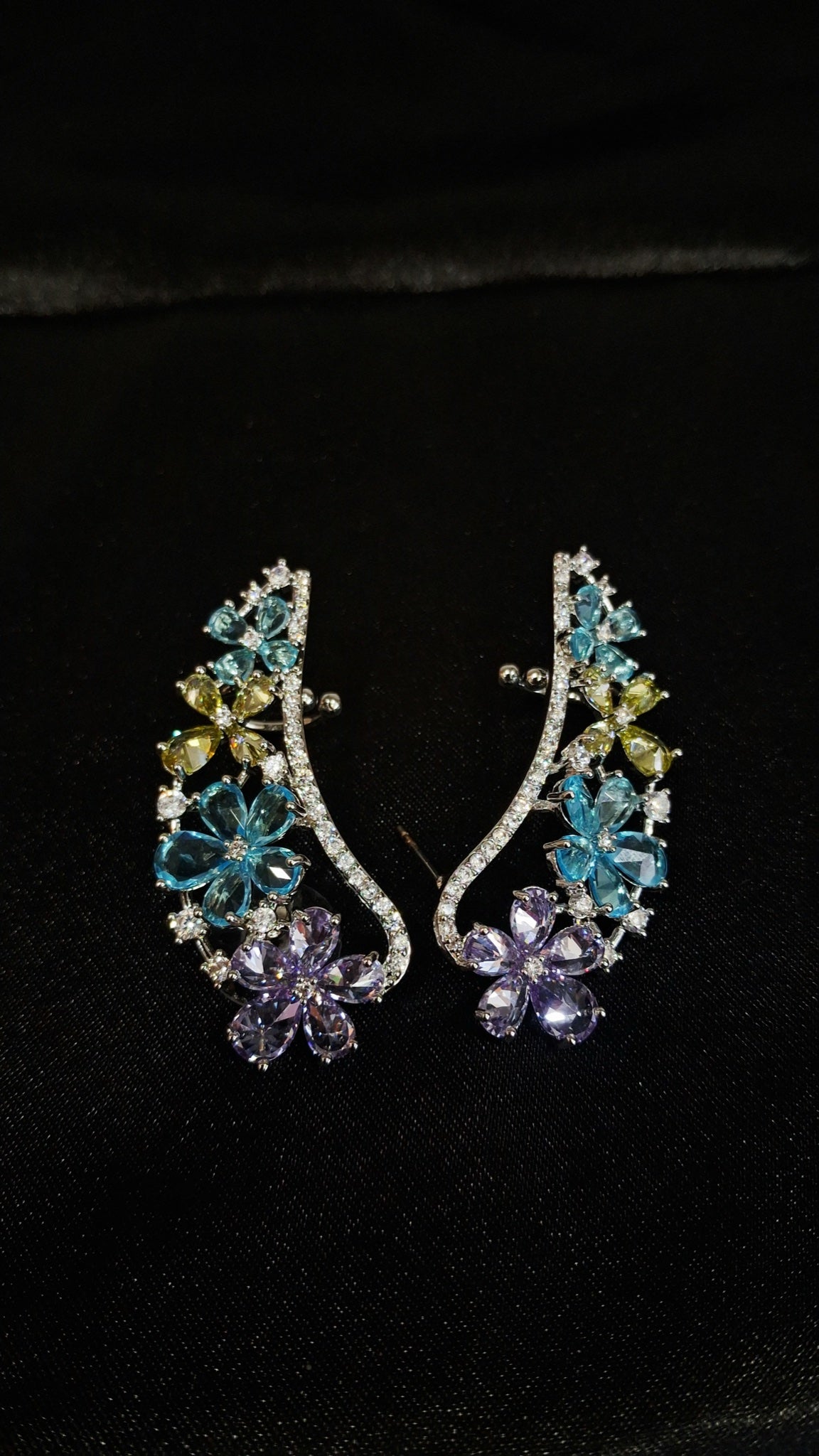 Pair of silver-tone floral ear cuffs with aqua, yellow and lavender stones