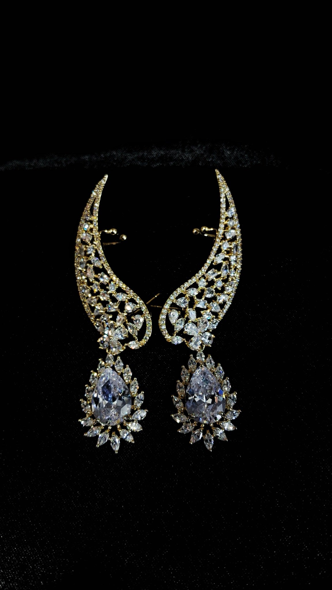 Gold-tone crystal wing ear cuffs with clear teardrop drops