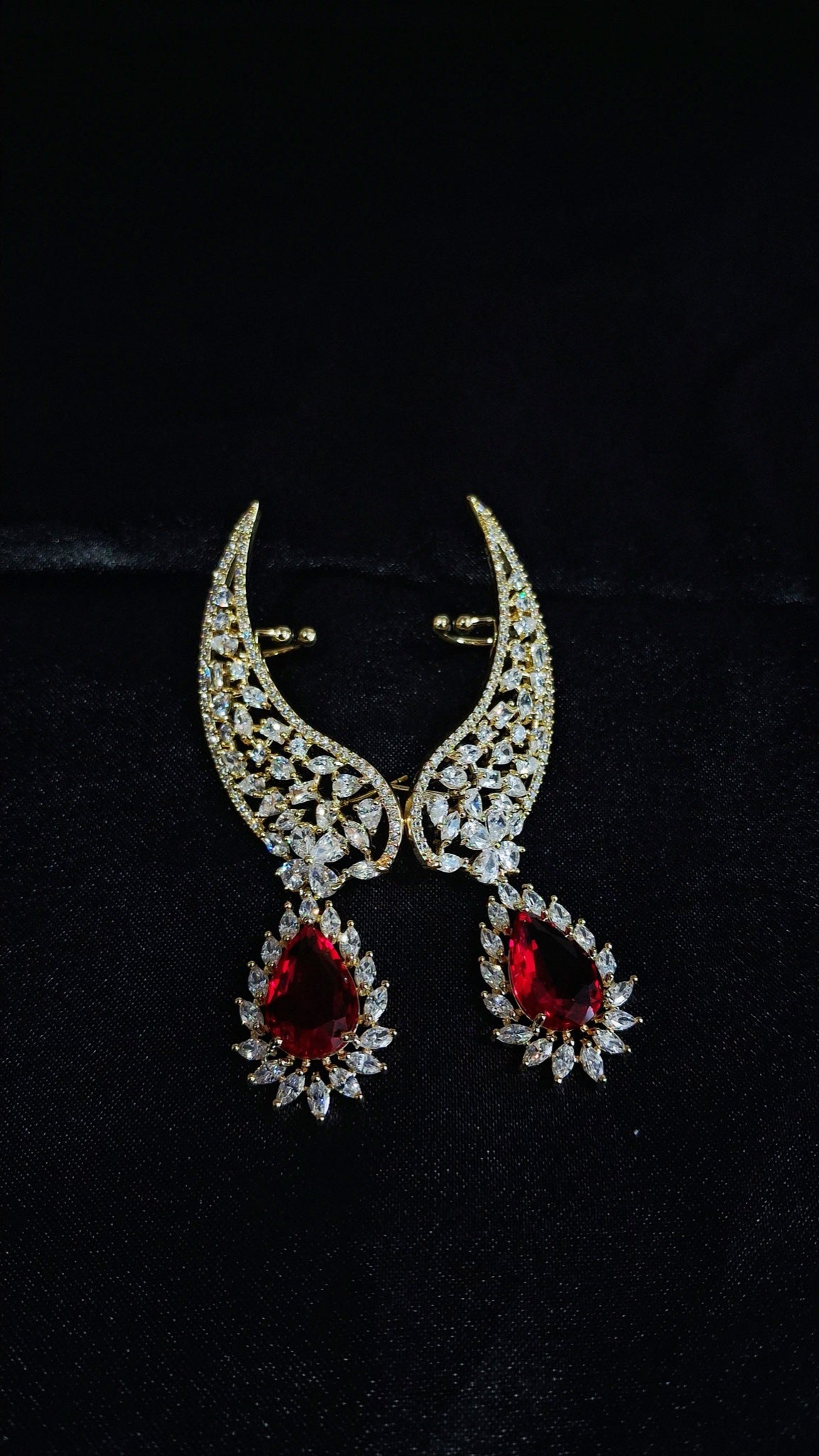 Gold-tone crystal wing ear cuffs with red teardrop drops