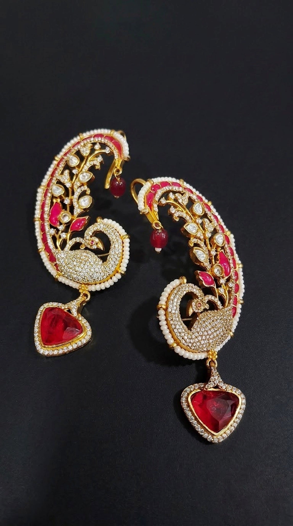 Gold-tone peacock paisley ear cuffs with kundan-look stones, faux pearls and red drop